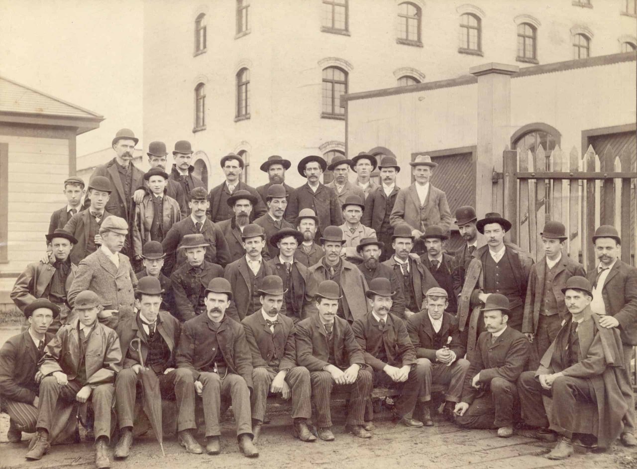 Group portrait of B.C. Sugar Refinery employees in front of Raymur Avenue entrance. ca 1892. City of Vancouver Archives, Bu P410.