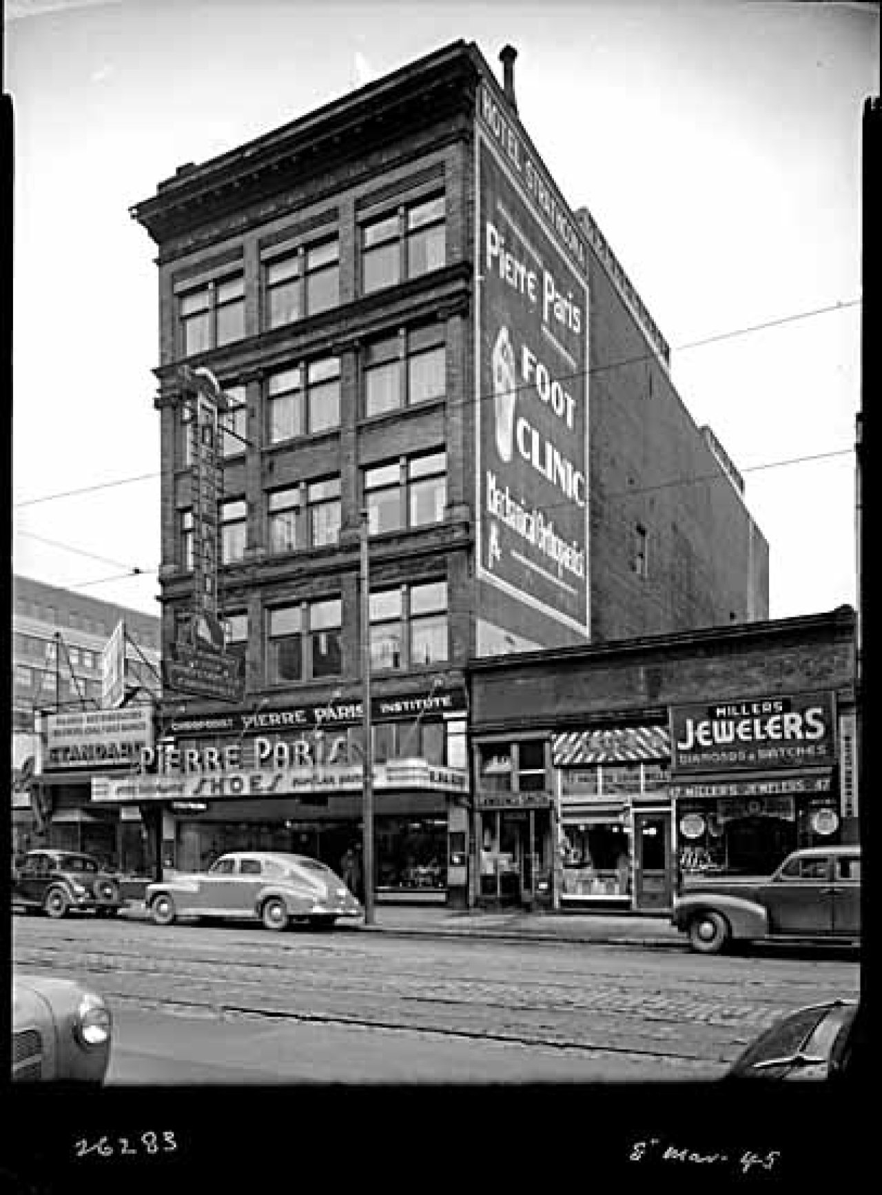 North side of 51 W Hastings St in 1945, including Pierre Paris Shoes and the Strathcona Hotel. Taken by Leonard Frank. Credit: Vancouver Public Library 5007