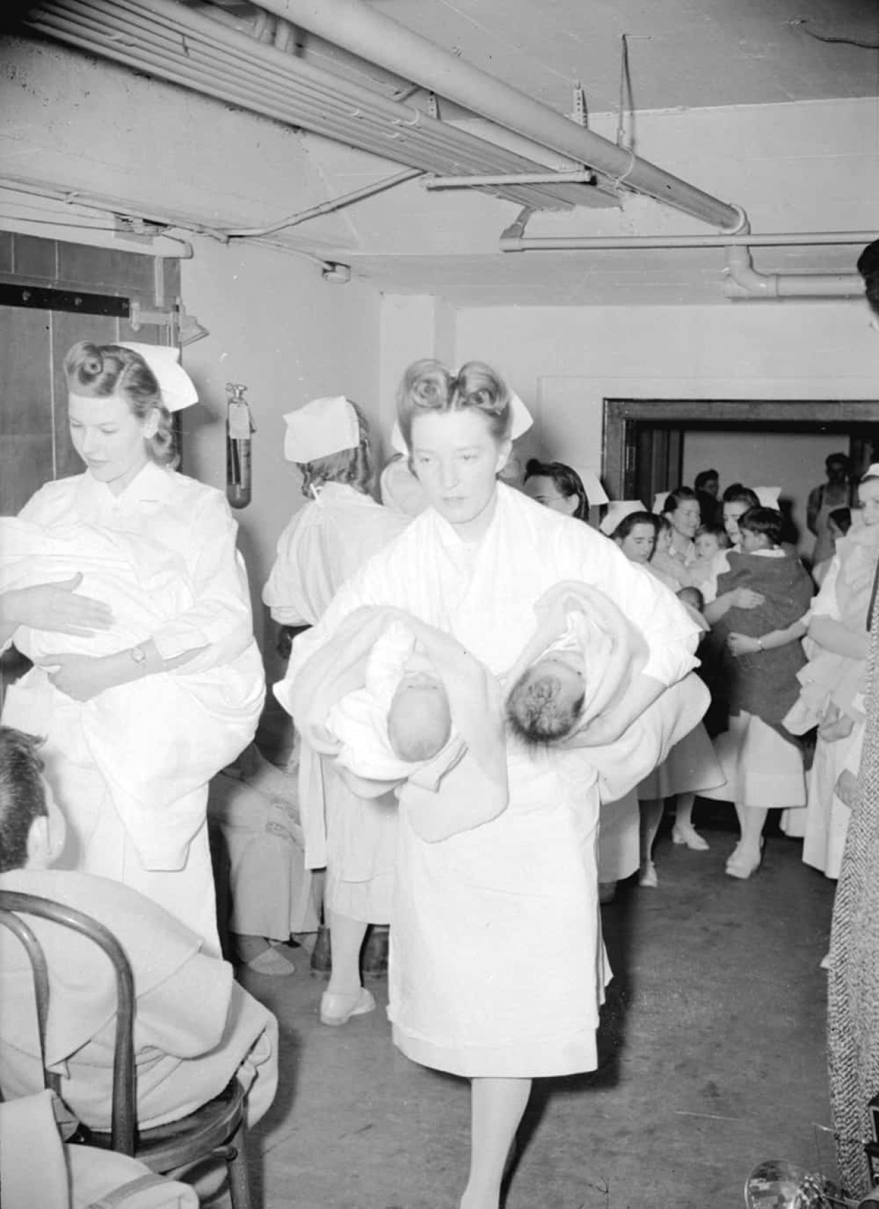 Nurse carrying two babies entering air raid shelter at St. Paul's Hospital in 1942. City of Vancouver Archives, CVA 1184-55. 