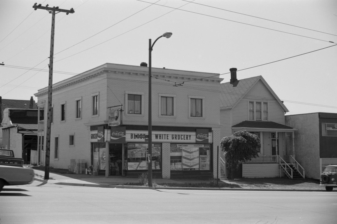 Exterior of the Black and White Grocery building at 574-592 E Broadway with Connaucher Residence to the right in 1978. Credit City of Vancouver Archives 786-56.11