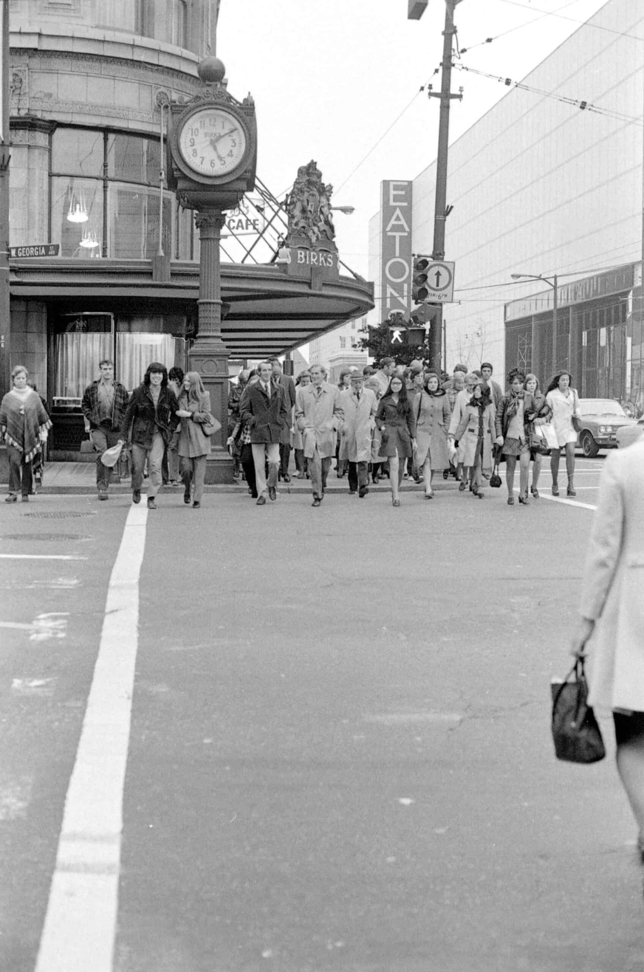 W. Georgia Street and Granville Street east crosswalk, looking southwest, with the Birks Clock visible circa 1972. City of Vancouver Archives, CVA 69-24.08.